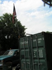 [Flag in a Garbage Container]